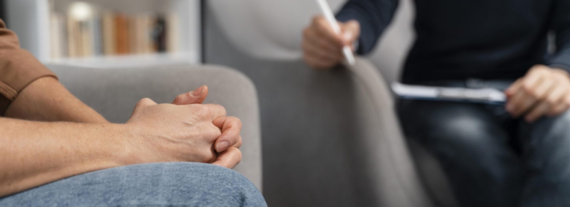 woman-with-hands-together-talking-with-counselor